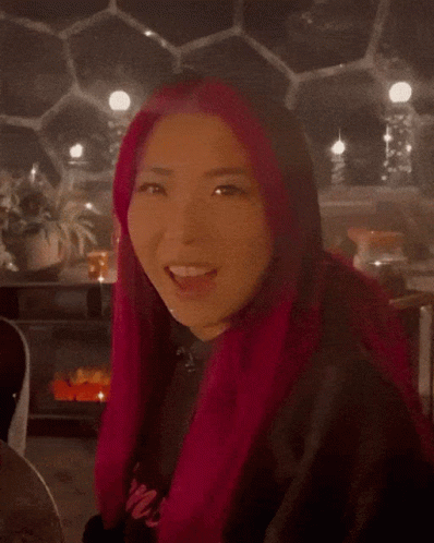 A Blurred Image Of A Person Wearing A Red Coat And A Black Shirt GIF