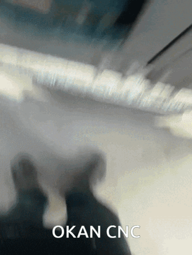 a blurred image of a person with the words okan cnc written below them