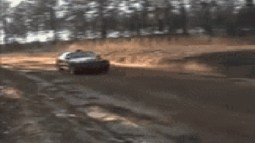 A Blurred Image Of A Red Car With A License Plate That Says ' Nc ' On It GIF