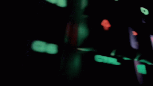A Blurred Image Of A Room With A Brick Wall And A Computer Monitor GIF