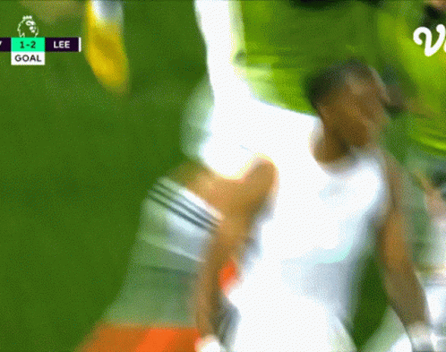 A Blurred Image Of A Soccer Game With The Score 1-2 Lee GIF