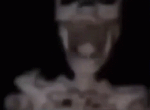 A Blurred Image Of A Table With A Lamp And A Vase On It . GIF