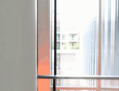 a blurred image of a window with a balcony behind it