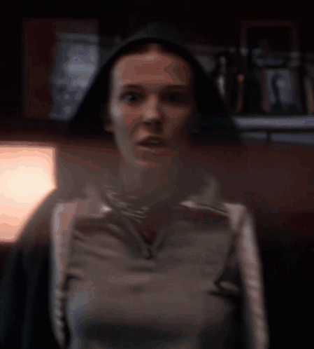 A Blurred Image Of A Woman Walking In Front Of A Car GIF