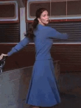 A Blurred Image Of A Woman With A Red Light Behind Her GIF