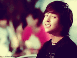 A Blurred Image Of A Young Man With A Necklace Around His Neck And A Black Shirt GIF
