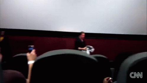 A Blurred Image Of People Watching A Movie With The Cnn Logo On The Bottom Left GIF