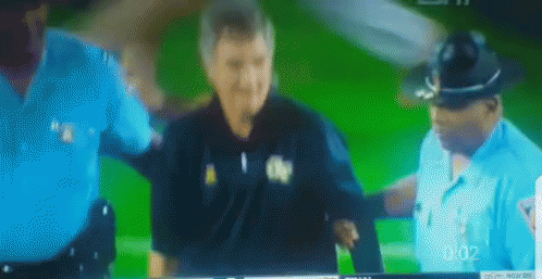 A Blurred Image Of Two Police Officers And A Man On A Green Screen With The Time 0:02 GIF