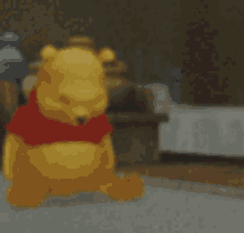 A Blurred Image Of Winnie The Pooh With A Red Shirt On GIF