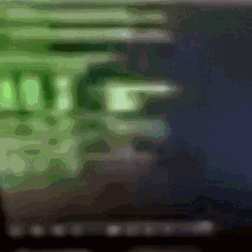 A Blurry Image Of A Computer Screen With A Green Glow GIF