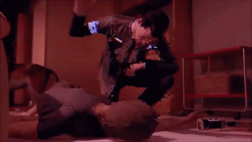 a blurry image of a man kneeling on a woman 's stomach