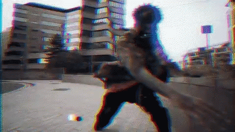 A Blurry Image Of A Person Standing On A Sidewalk With A Building In The Background GIF