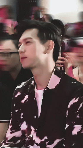 A Blurry Photo Of A Man In A Black And White Shirt With The Letters Yz On The Bottom Right GIF