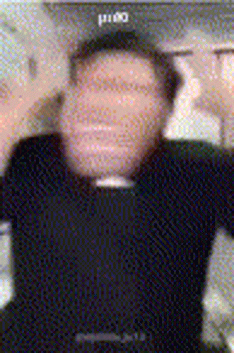 A Blurry Photo Of A Man Wearing A Black Shirt And A Black Hat GIF