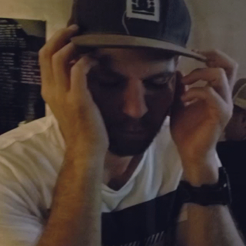 A Blurry Photo Of A Man Wearing A Hat That Says ' S ' On It GIF