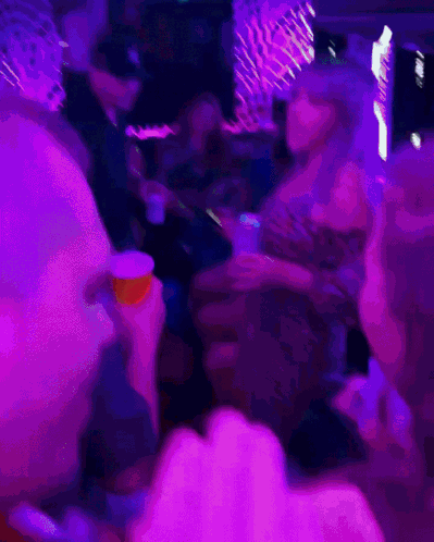 A Blurry Photo Of A Woman Dancing In A Club GIF