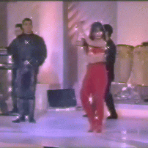 a blurry photo of a woman in red pants dancing on a stage