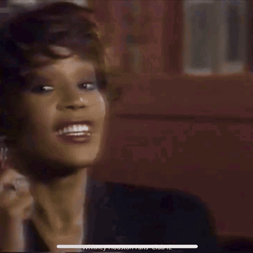 A Blurry Photo Of A Woman With The Words Whitney Houston Fans Club Je On The Bottom GIF