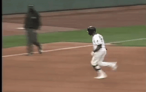 A Blurry Picture Of A Baseball Game With A Coca Cola Ad In The Background GIF
