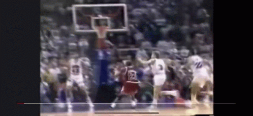 a blurry picture of a basketball game with a player wearing a jersey with the number 23 on it .