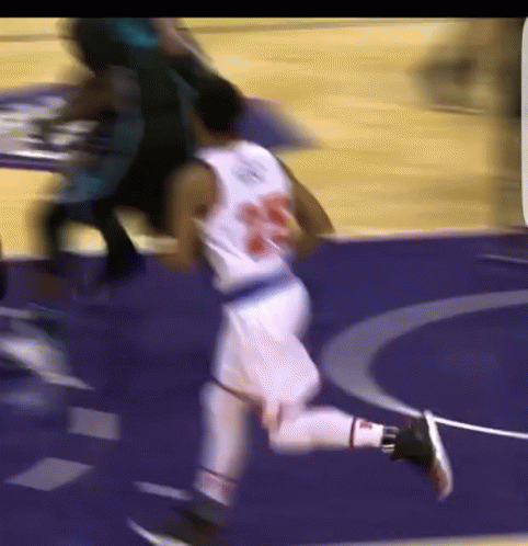A Blurry Picture Of A Basketball Player Wearing Number 23 GIF