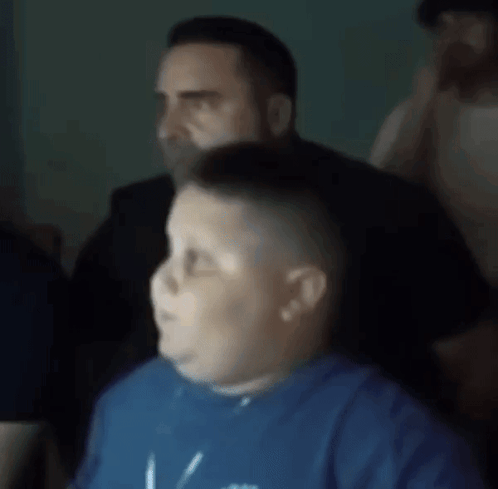 A Blurry Picture Of A Boy Wearing A Blue Shirt That Says ' I Love You ' On It GIF