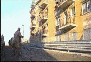 A Blurry Picture Of A Building With Balconies On The Side GIF