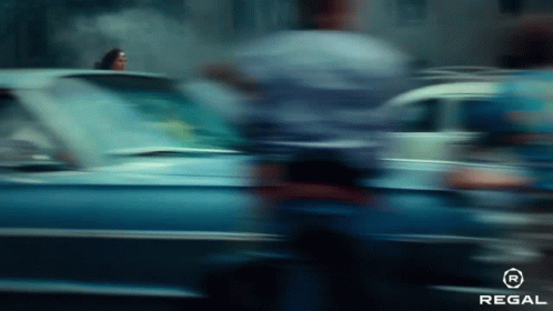 A Blurry Picture Of A Car Driving Down A Street GIF