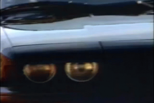 A Blurry Picture Of A Car 'S Headlights And Windshield GIF