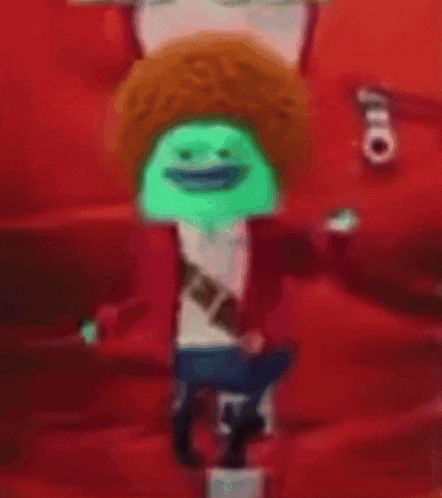 A Blurry Picture Of A Cartoon Character With A Green Hat GIF