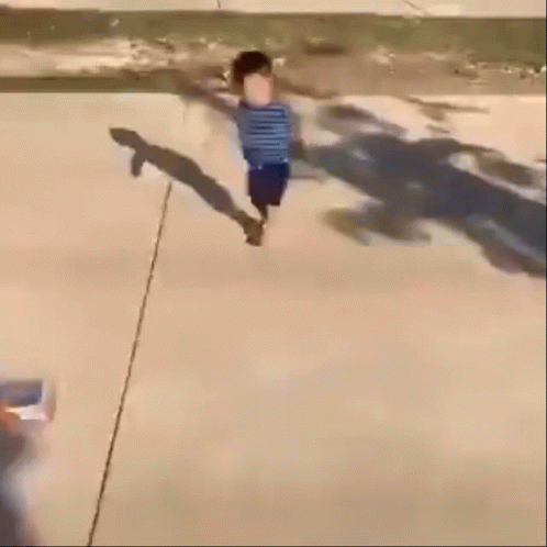 A Blurry Picture Of A Child Walking Down A Street GIF