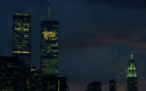A Blurry Picture Of A City At Night With A Few Buildings Lit Up GIF