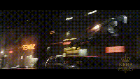 A Blurry Picture Of A City At Night With A Sign That Says 78 On It GIF