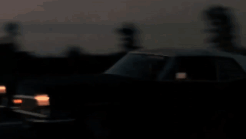 A Blurry Picture Of A City Skyline At Sunset With The Twin Towers Visible GIF
