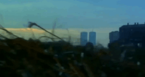 A Blurry Picture Of A City Skyline With A Few Buildings In The Background GIF