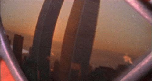 A Blurry Picture Of A City Skyline With A Few Buildings In The Foreground GIF
