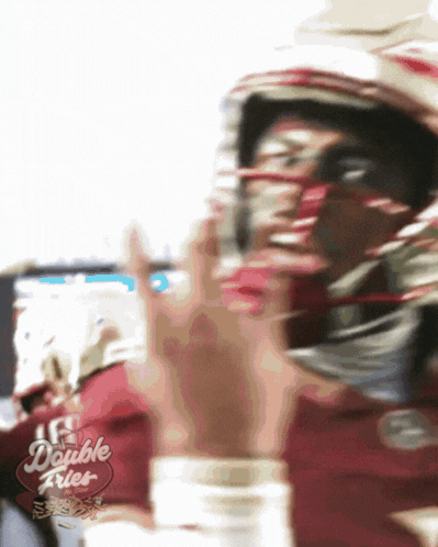 a blurry picture of a football player with a double fries sign in the corner