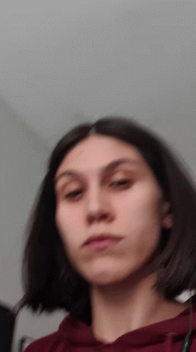 A Blurry Picture Of A Girl With Short Hair GIF