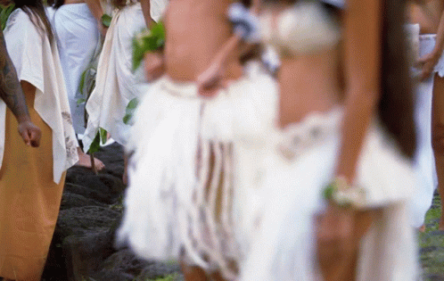 A Blurry Picture Of A Group Of People In White Dresses GIF