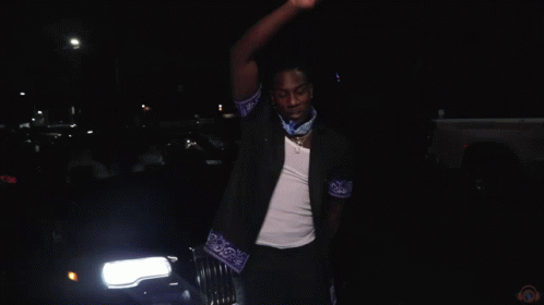 A Blurry Picture Of A Group Of People With The Letter M In The Middle GIF
