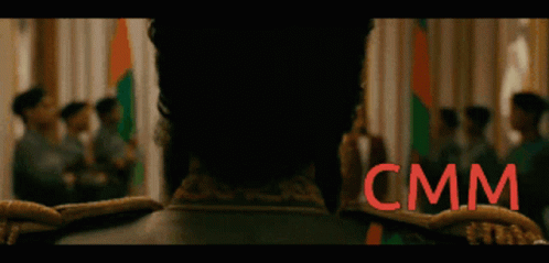 Blurry Group Of People With CMM Sign GIF