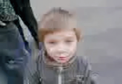 A Blurry Picture Of A Little Boy Holding A Person 'S Hand . GIF