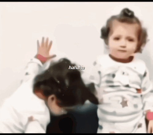 A Blurry Picture Of A Little Girl And A Dog With The Words '  Hahaha ' On The Bottom GIF