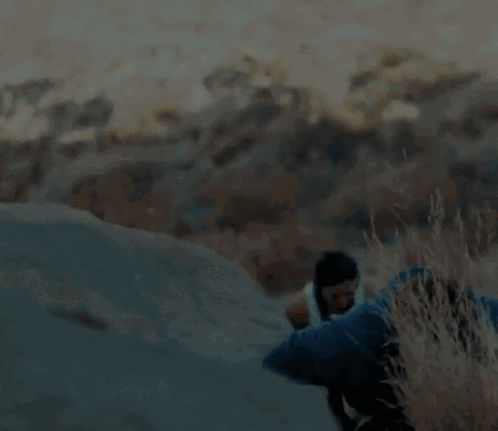A Blurry Picture Of A Man And A Woman Hiking Up A Hill GIF