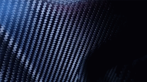 A Blurry Picture Of A Man Holding A Black Object In His Hand GIF