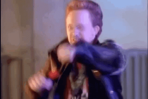 A Blurry Picture Of A Man Holding A Gun In A Room . GIF