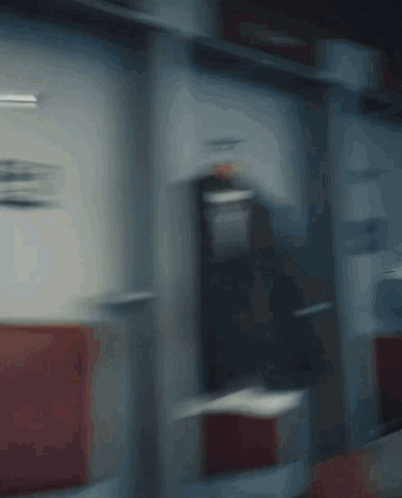 A Blurry Picture Of A Man Holding A Red Fire Extinguisher GIF