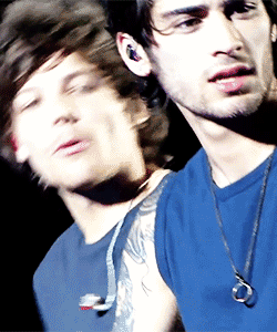 A Blurry Picture Of A Man In A Blue Shirt GIF