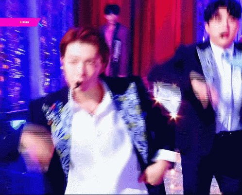 A Blurry Picture Of A Man In A Suit And Tie Dancing GIF