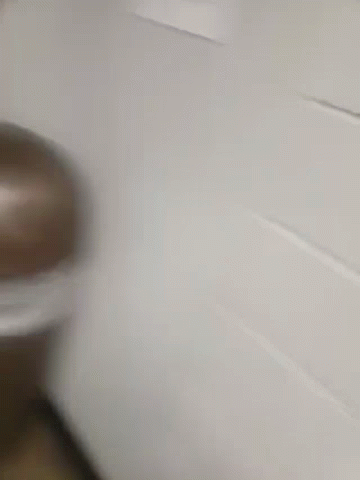A Blurry Picture Of A Man In A Yellow Jacket Taking A Picture Of Himself In A Mirror GIF